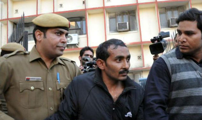 Indian police are shown escorting former Uber taxi driver and rapist Shiv Kumar Yadav (center) following his court appearance in New Delhi on Dec. 8, 2014.