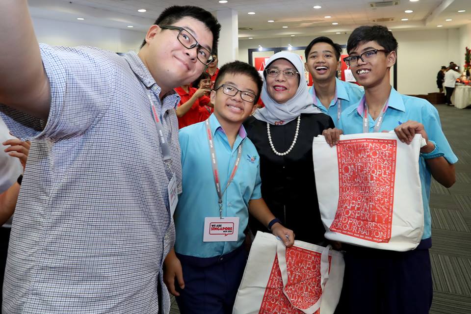 Students of special education schools taking a selfie along with President of Singapore President Halimah Yacob. They have utilised their artistic skills in designing the funpacks. 
