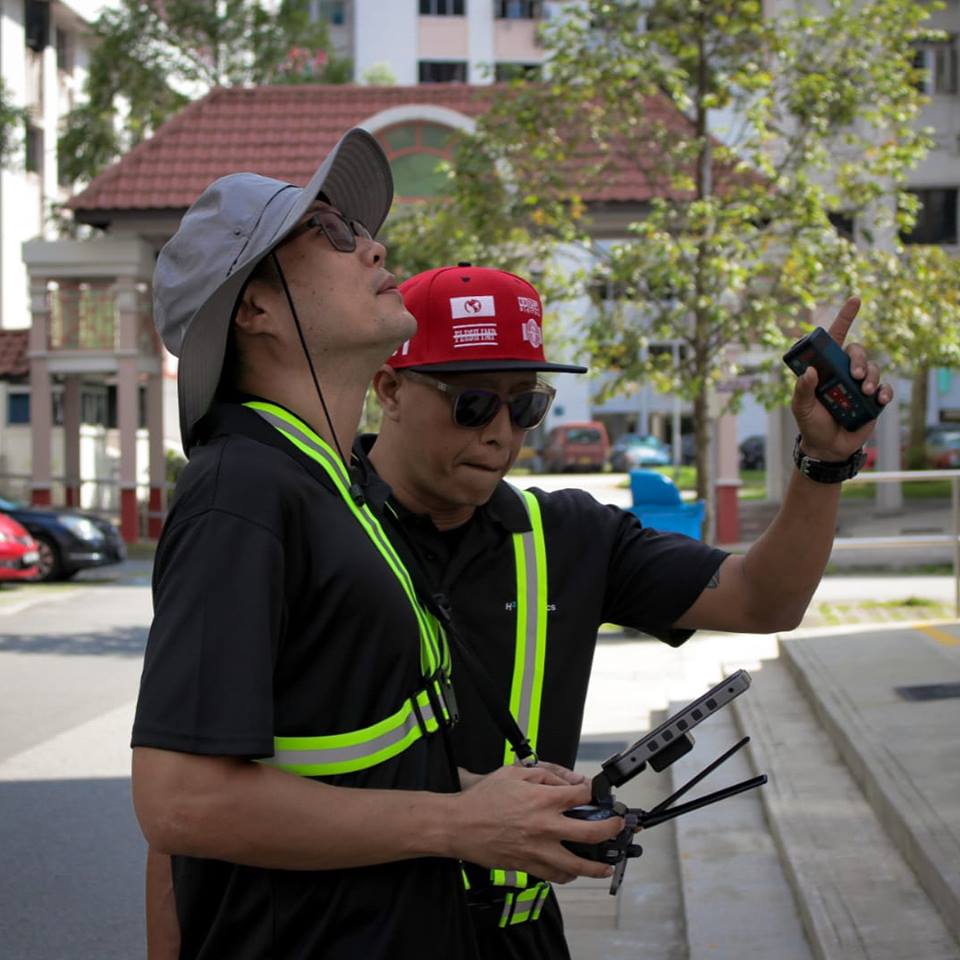 Personnel of Performance Rotors operating drones at HDB block in Jurong East. Photo courtesy: Facebook page of Performance Rotors 