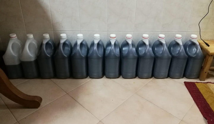 HSA authorities seized stocks of prepared cough syrup stored in large plastic containers from the HDB flat. Photo courtesy: HSA