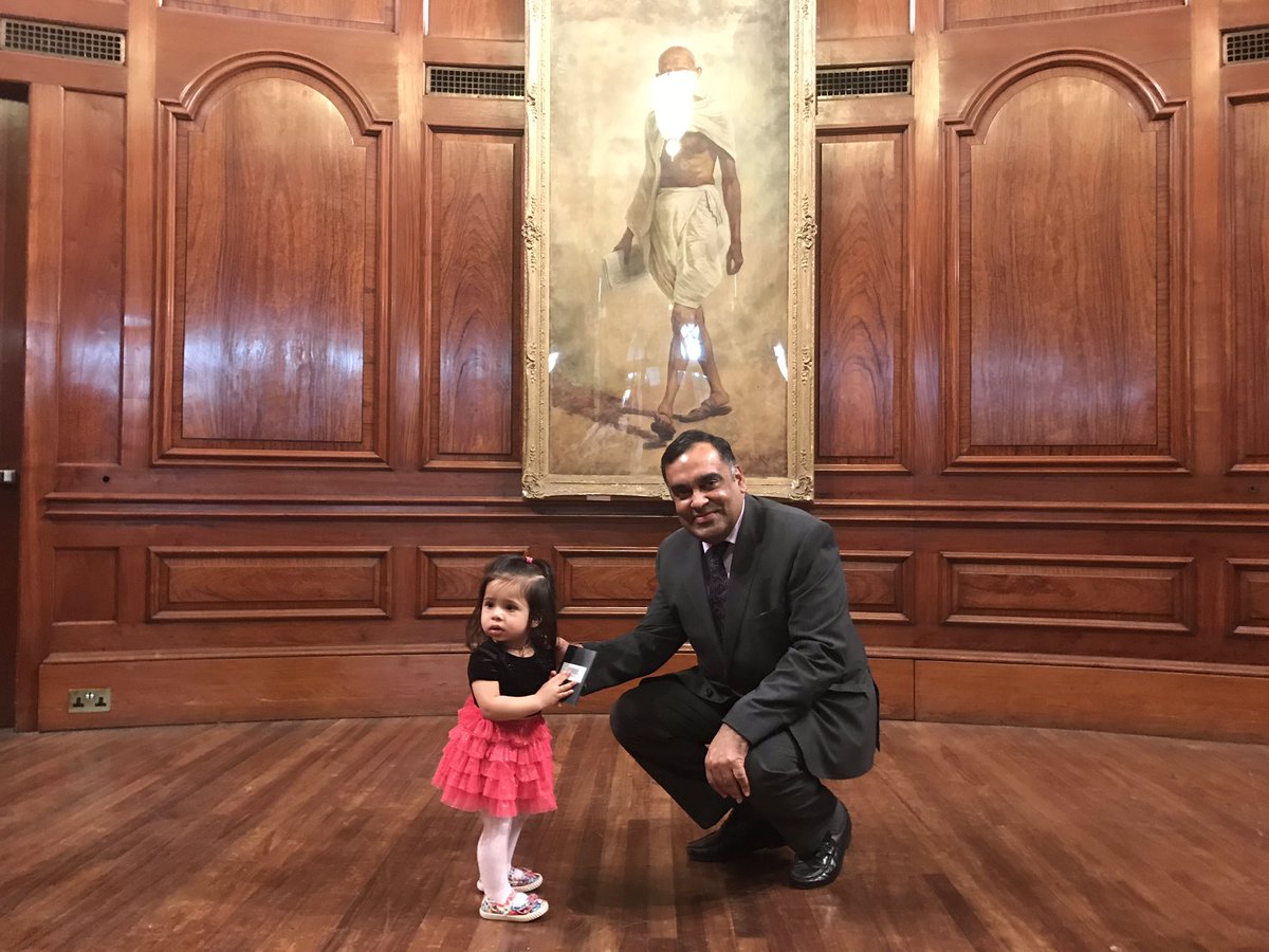 Forteen month old Darlene Fernandes looks askance after Indian High Commissioner to UK Y K Sinha presents her with passport (Photo courtesy: High Commission of India, London