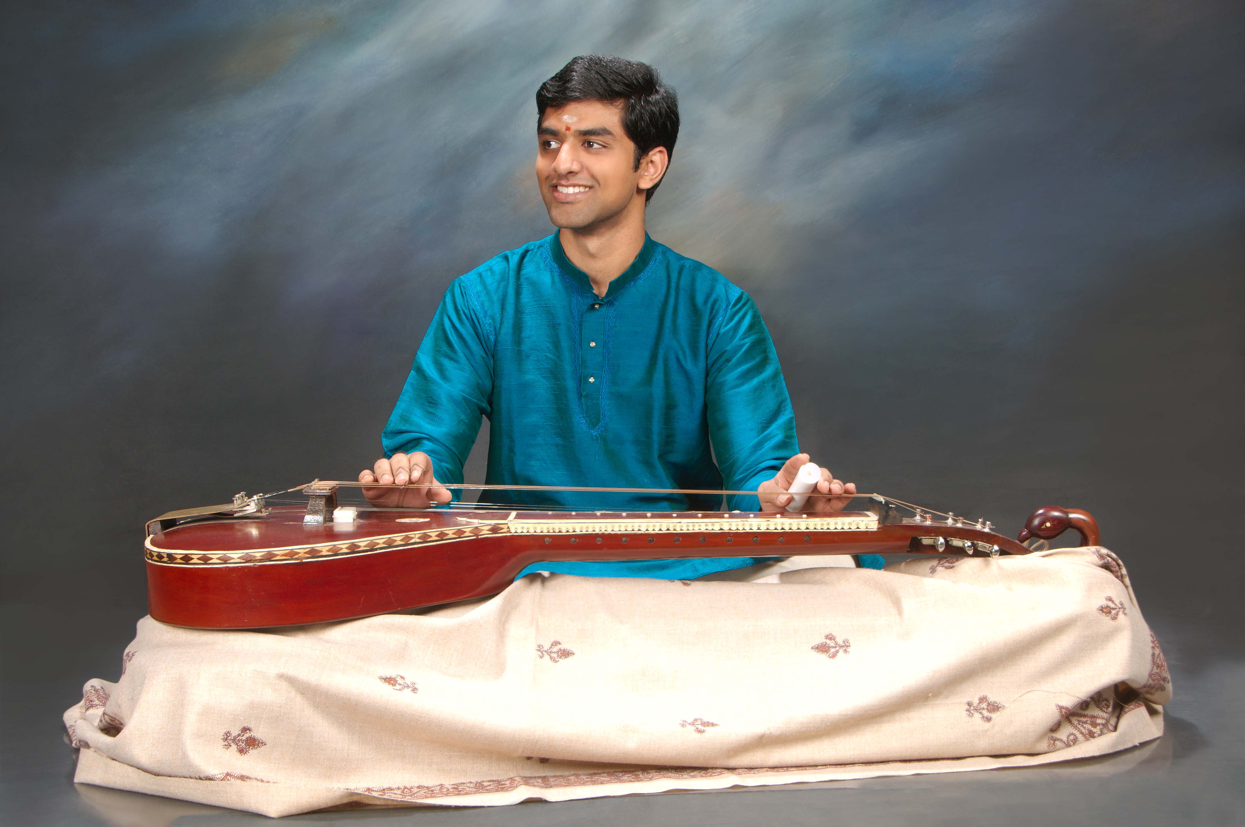 It is a unique experience to watch Vishaal Sapuram as his nimble fingers strum and glide across the fretless strings of chitravina. Photo courtesy: Esplanade Theatres on the Bay  