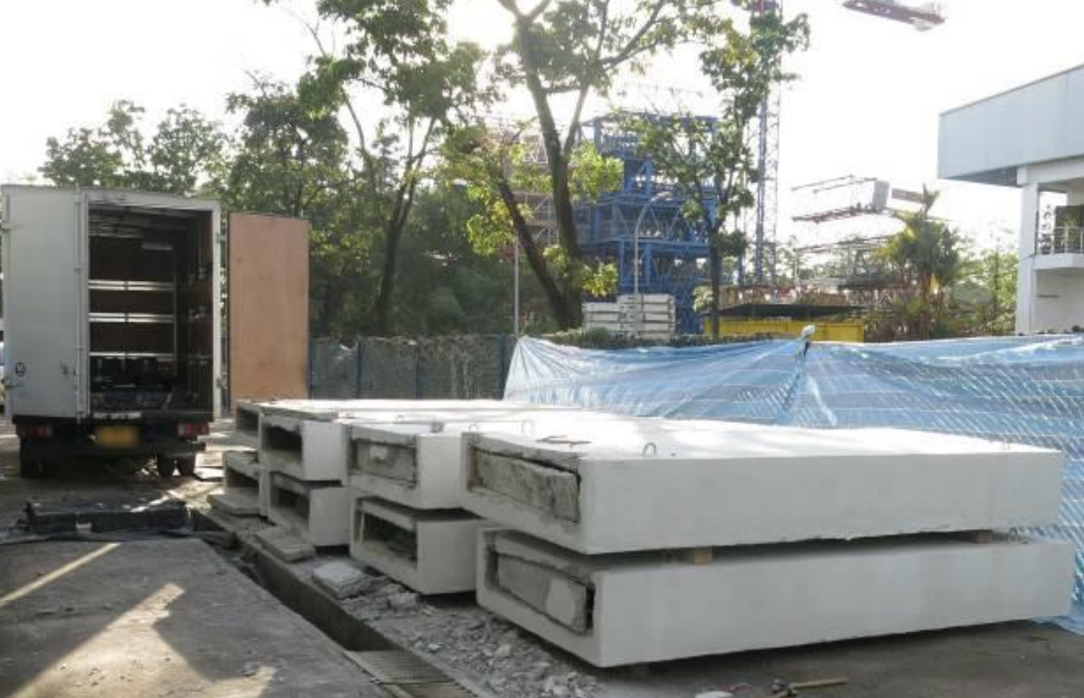 Singapore Customs officers raided a yard in Tuas Avenue 14 on 24 November 2018 and arrested four men who were retrieving duty-unpaid cigarettes that were hidden in concrete slabs and loading them onto a lorry. Photo courtesy: Singapore Customs