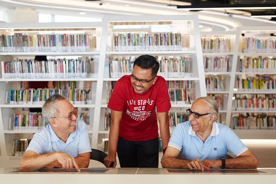 Adults and teens can connect with current affairs by reading eNewspapers at the library. Photo courtesy: Facebook page of  National Library Board