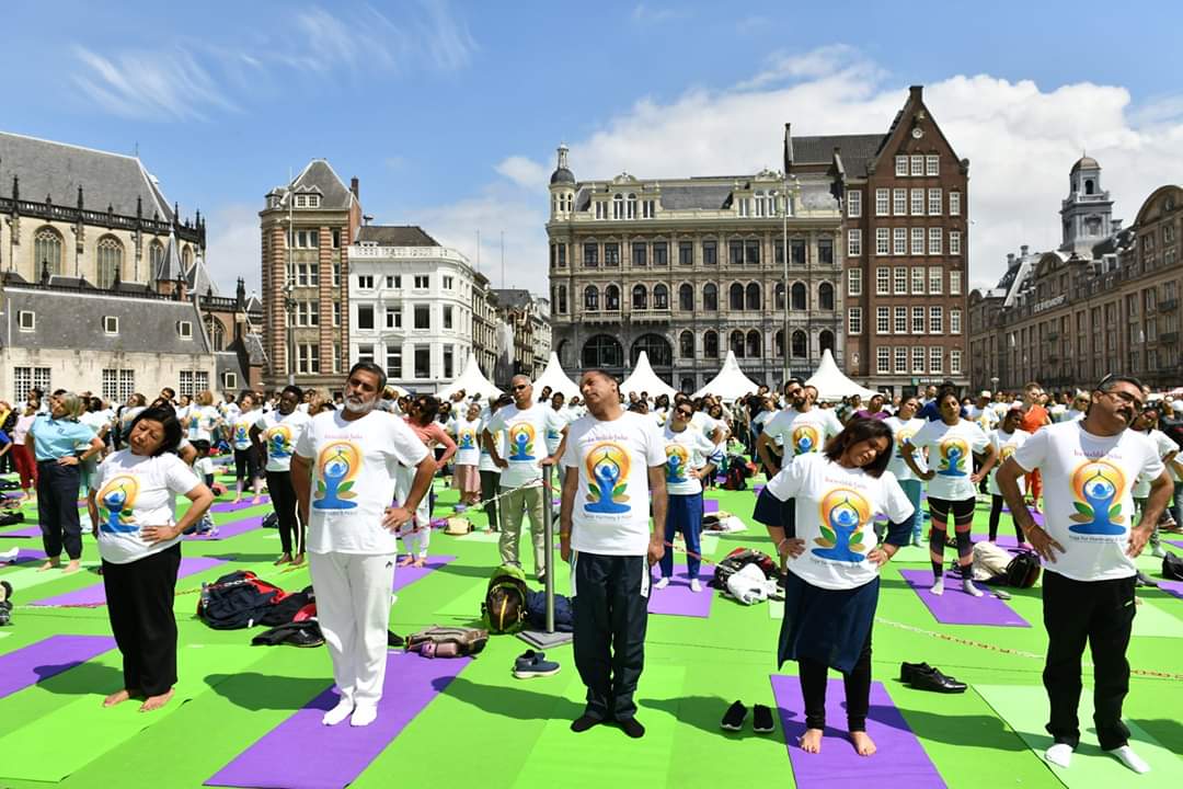 International Day of Yoga 2019 celebrations in the iconic Dam Square in Amsterdam organised by the Embassy of India in the Netherlands, featuring yoga sessions, Indian handicrafts and dance and music. Photo courtesy: Twitter/@IndinNederlands